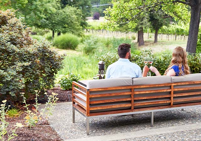 Couple enjoying wine on J Winery Grounds