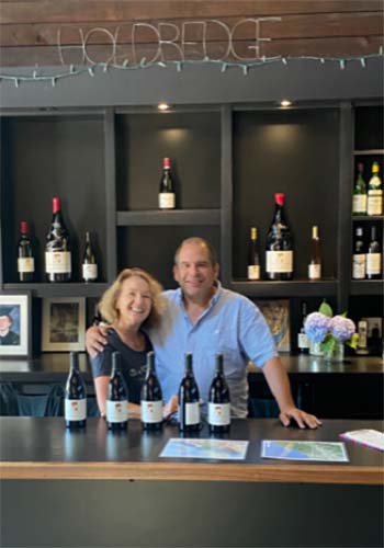 John and Carri Holdredge behind bar in Holdredge tasting room