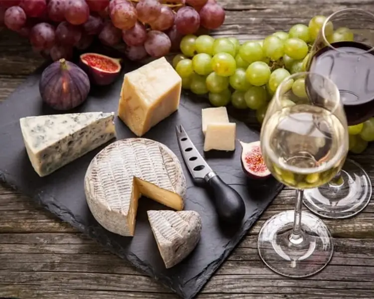 Assortment of cheese, grapes and wine